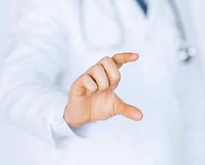 Image showing male doctor holding something in his hand