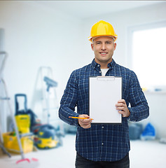 Image showing smiling male builder in helmet with clipboard