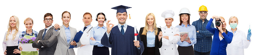 Image showing happy bachelor with diploma over professionals