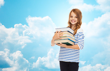 Image showing happy little student girl with many books