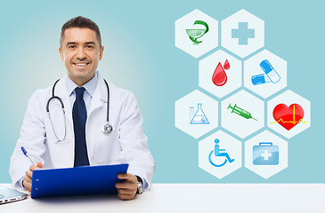 Image showing happy doctor with clipboard and medical icons