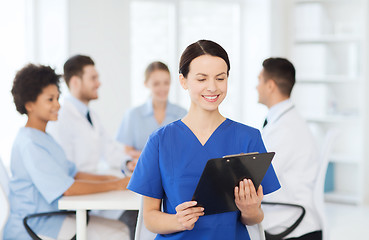 Image showing happy doctor over group of medics at hospital