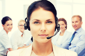 Image showing helpline operator with headphones in call centre