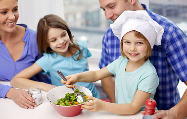 Image showing happy family with two kids cooking at home