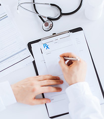 Image showing male doctor writing prescription paper