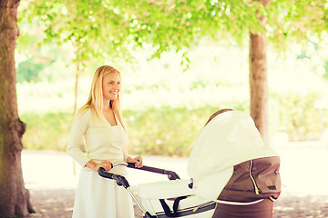 Image showing happy mother with stroller in park