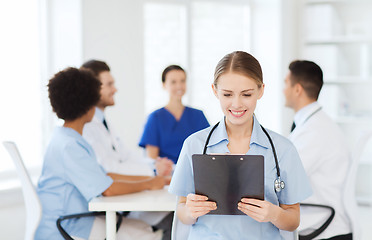 Image showing happy doctor over group of medics at hospital