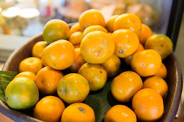 Image showing basket of fresh ripe juicy oranges at kitchen