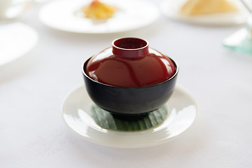 Image showing ceramic pot with hot dish on restaurant table