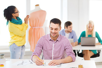 Image showing smiling fashion designers working in office