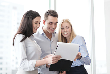 Image showing business team looking at clipboard