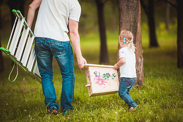 Image showing Father making birdhouse with daughter