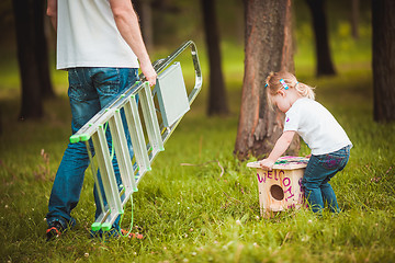 Image showing Father making birdhouse with daughter