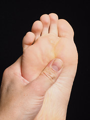 Image showing Pressure point massage under foot with thumb isolated towards bl