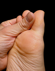 Image showing Thumb pressure on big toe massage on dry skin isolated towards b
