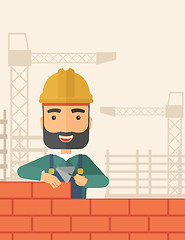 Image showing Builder man is building a brick wall.