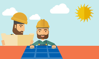 Image showing Man putting a solar panel on the roof.