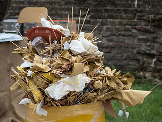 Image showing Overfull garbage can trash in festival