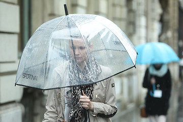 Image showing Woman with transparent umbrella on street