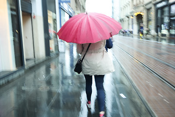 Image showing Motion of woman with pink ubrella