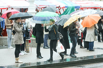 Image showing Group of people with umbrellas