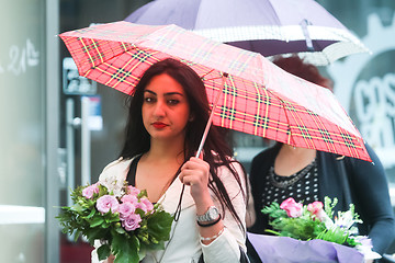 Image showing Woman with posy on street