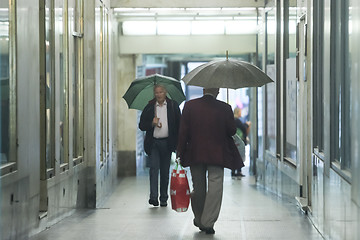 Image showing Senior adults walking in passage