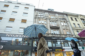 Image showing People with umbrellas on rainy day