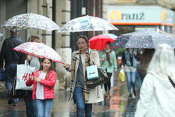 Image showing People with umbrellas on street