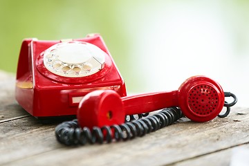 Image showing Red phone on wooden deck