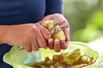 Image showing Potato is peeled with a kitchen knife