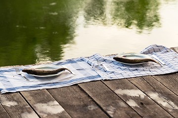 Image showing Wooden deck with fish on it