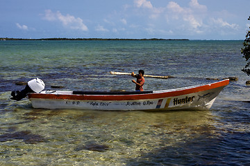 Image showing a man and his white boat