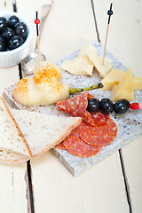 Image showing mix cold cut on a stone with fresh pears