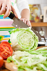 Image showing Woman\'s hands cutting vegetables