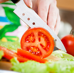 Image showing Woman\'s hands cutting tomato