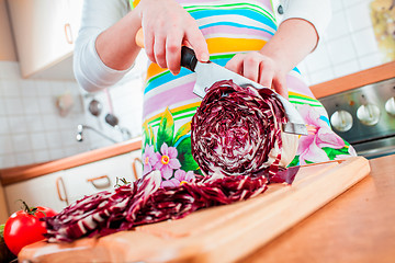 Image showing Woman\'s hands cutting red cabbage