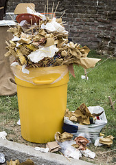 Image showing Overfull garbage can trash in festival