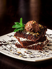 Image showing Chocolate brownie cake with a scoop of ice cream.