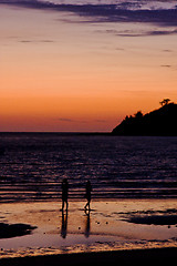 Image showing two men in the sunset and the mountain