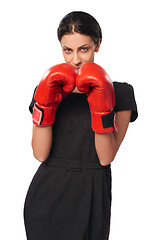 Image showing Serious business woman wearing boxing gloves