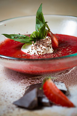 Image showing strawberry soup with ice cream and mint on a plate decoratedfresh strawberries