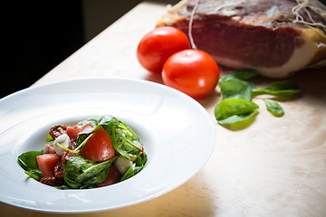 Image showing Salad with strawberry, prosciutto, herbs, cottage cheese and blackberry balsamic vinegar.