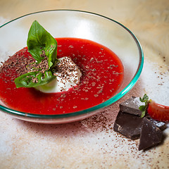 Image showing strawberry soup with ice cream and mint on a plate decoratedfresh strawberries