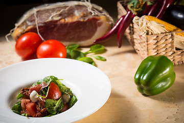 Image showing Salad with strawberry, prosciutto, herbs, cottage cheese and blackberry balsamic vinegar.