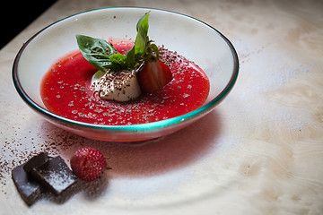 Image showing strawberry soup with ice cream and mint on a plate decoratedfresh strawberries