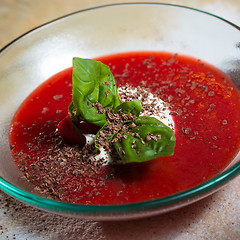 Image showing strawberry soup with ice cream and mint on a plate decoratedfresh strawberries