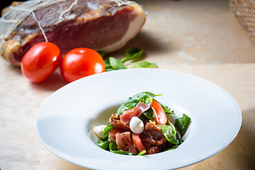 Image showing Salad with strawberry, prosciutto, herbs, cottage cheese and blackberry balsamic vinegar.