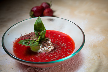 Image showing strawberry soup with ice cream and mint on a plate decoratedfresh strawberries