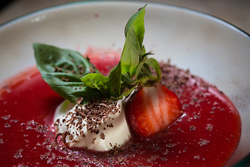 Image showing strawberry soup with ice cream and mint on a plate decoratedfresh strawberries